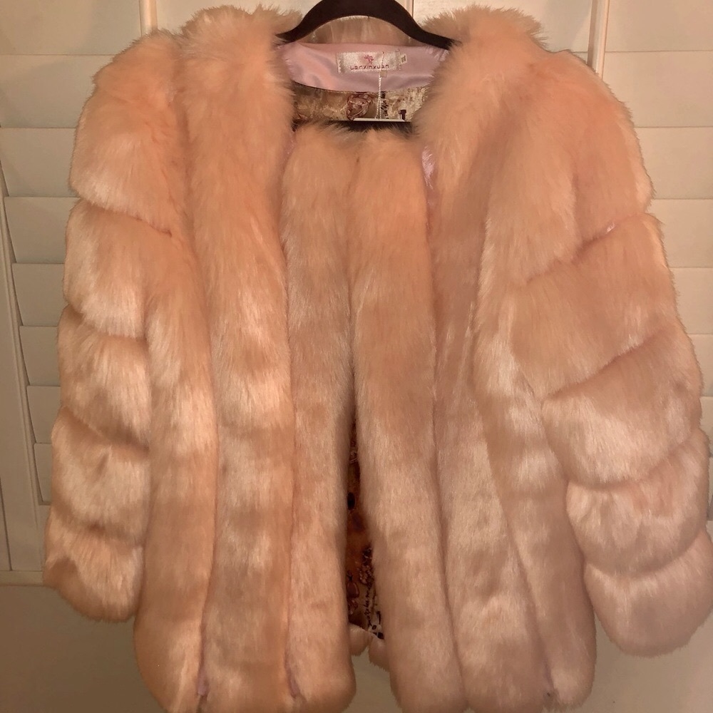 Soft pink faux fur coat. Warm snuggly. Unique lining. Side pockets.